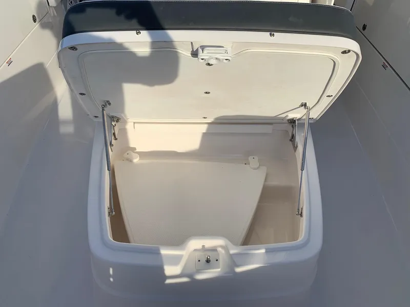 Slide: The Image of Open storage compartment on the 2024 Robalo R360 boat. - 24