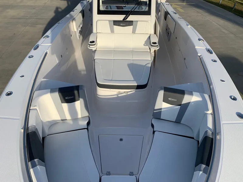 Slide: The Image of 2024 Robalo R360 boat interior with white and gray seating. - 6