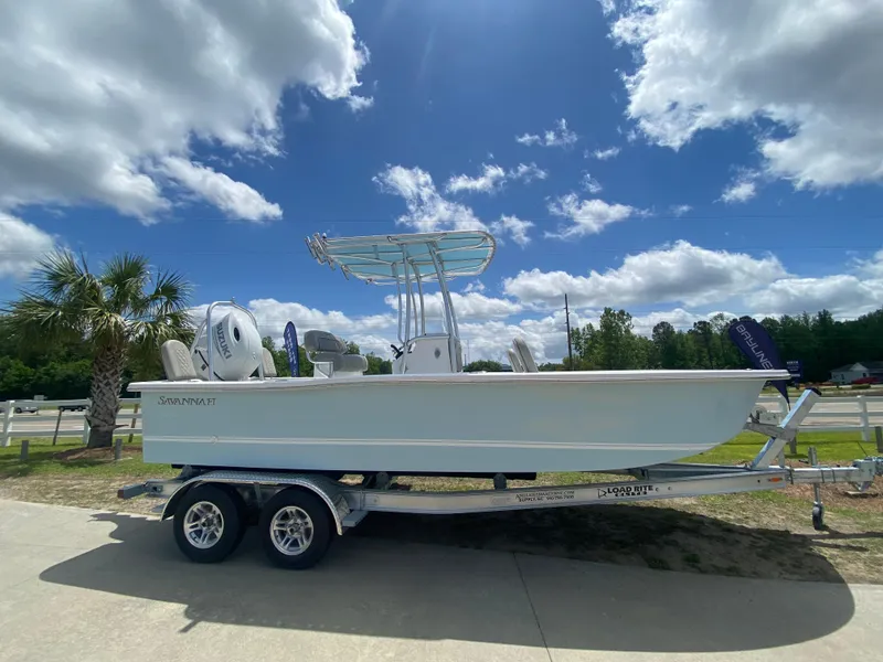 Slide: The Image of 2024 Savannah SS21 boat on a trailer under a sunny sky. - 0
