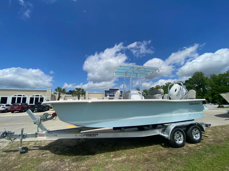Slide: The Image of 2024 Savannah SS21 boat on a trailer under a blue sky. - 1