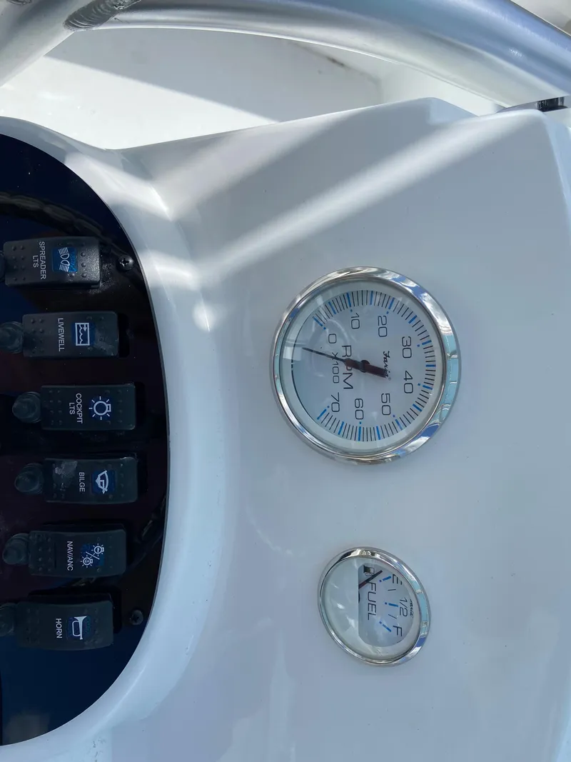 Slide: The Image of Control panel of a 2024 Savannah SS21 boat with gauges and switches. - 18