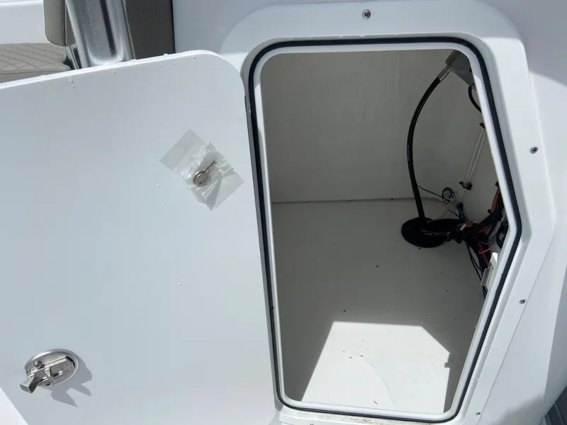 Slide: The Image of Open storage compartment on a 2024 Savannah SS21 boat. - 22