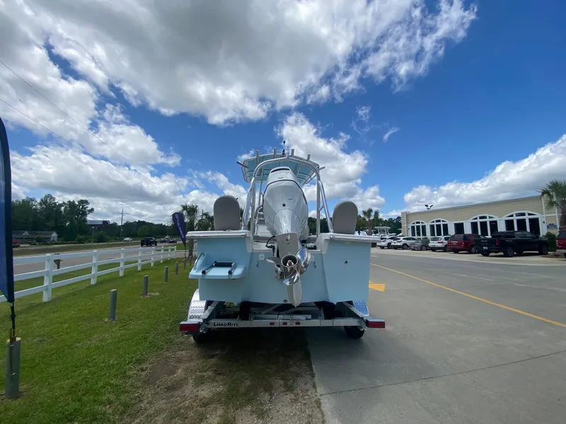Slide: The Image of 2024 Savannah SS21 boat on trailer under a partly cloudy sky. - 3