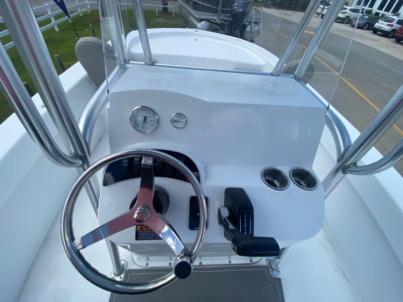 Slide: The Image of 2024 Savannah SS21 boat helm with steering wheel, gauges, and controls. - 8