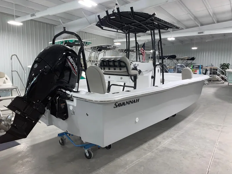 Slide: The Image of 2024 Savannah SS21 boat in showroom with Mercury outboard motor. - 2