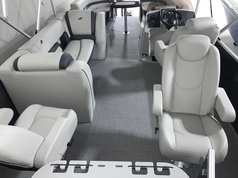 Slide: The Image of 2024 Starcraft EX22 FD boat interior with plush seating and modern helm. - 11