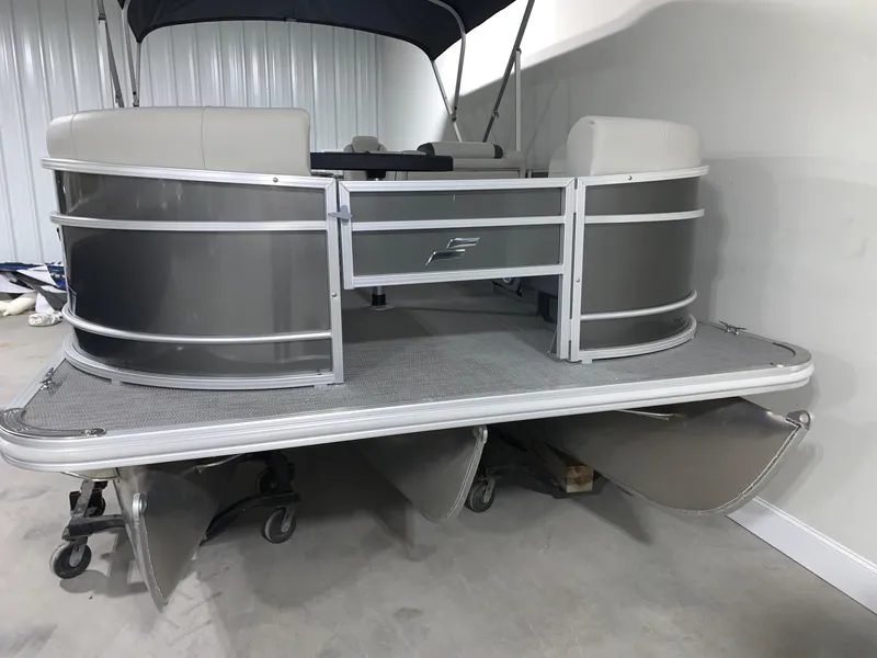 Slide: The Image of 2024 Starcraft EX22 FD pontoon boat in a showroom. - 3