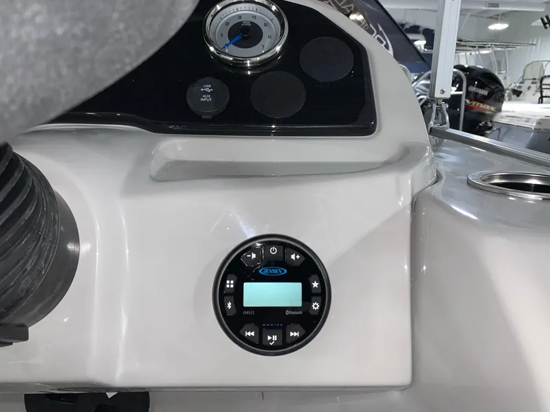 Slide: The Image of 2024 Starcraft EX22 FD boat dashboard with control panel and gauge. - 15