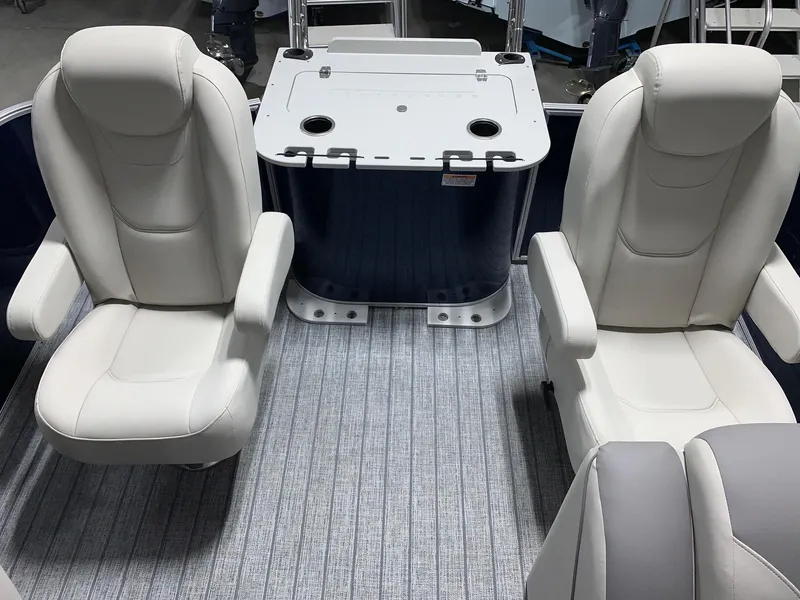 Slide: The Image of 2024 Starcraft EX22 FD boat interior with white seats and a central console. - 17