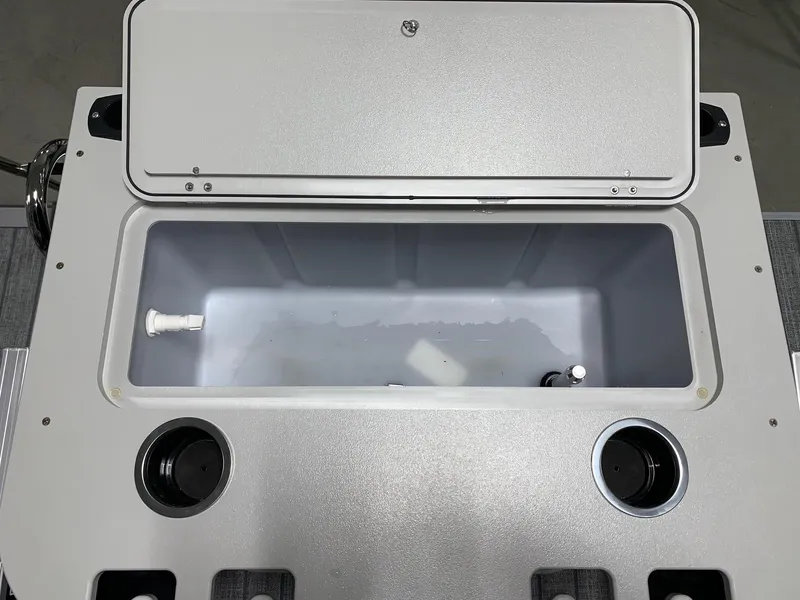 Slide: The Image of 2024 Starcraft EX22 FD boat storage compartment with cup holders. - 19