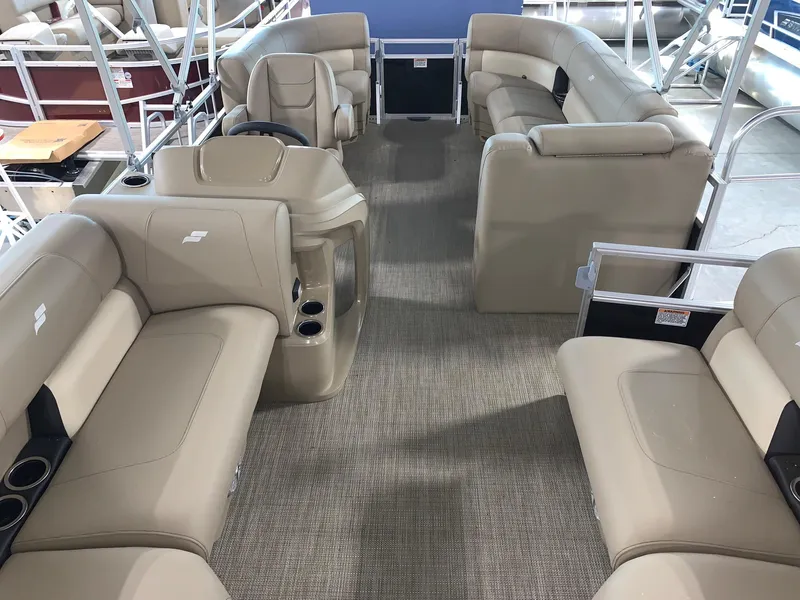Slide: The Image of 2024 Starcraft LX20 R pontoon boat interior with beige seating and steering console. - 3