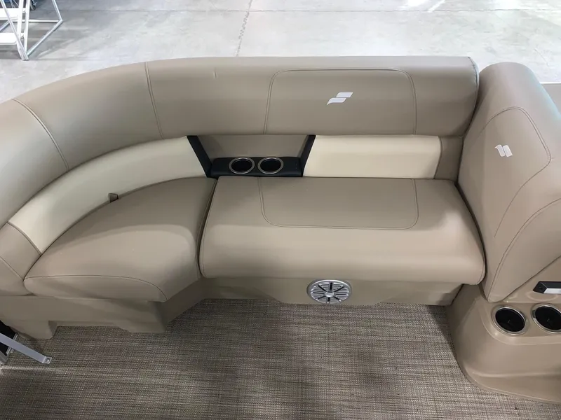 Slide: The Image of 2024 Starcraft LX20 R boat interior seating with cup holders and speaker. - 5