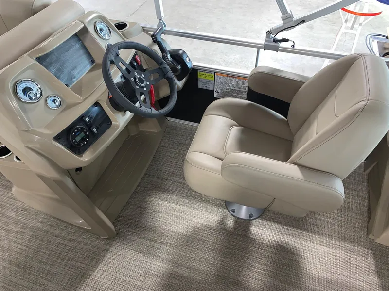 Slide: The Image of 2024 Starcraft LX20 R boat helm with beige captain's chair and modern dashboard. - 6