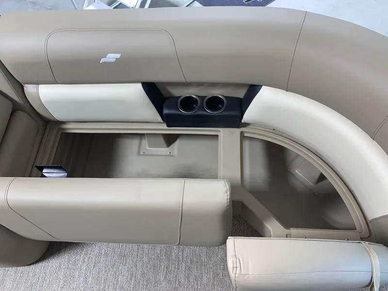 Slide: The Image of 2024 Starcraft LX22 R boat interior with beige seating and cup holders. - 12