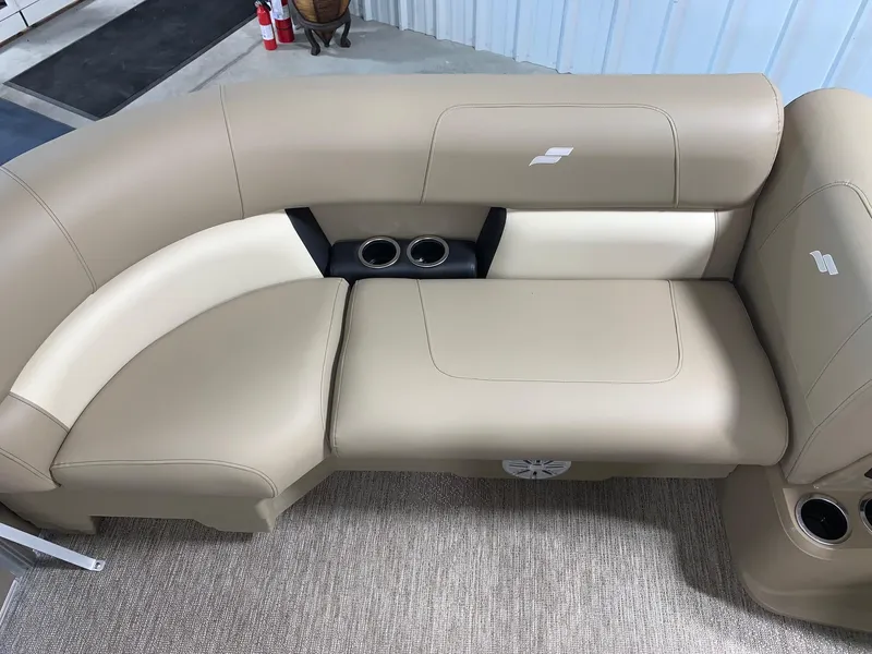 Slide: The Image of 2024 Starcraft LX22 R boat interior with beige leather seating and cup holders. - 13