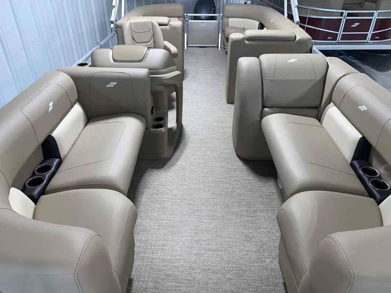 Slide: The Image of 2024 Starcraft LX22 R pontoon boat interior with beige seating and cup holders. - 14