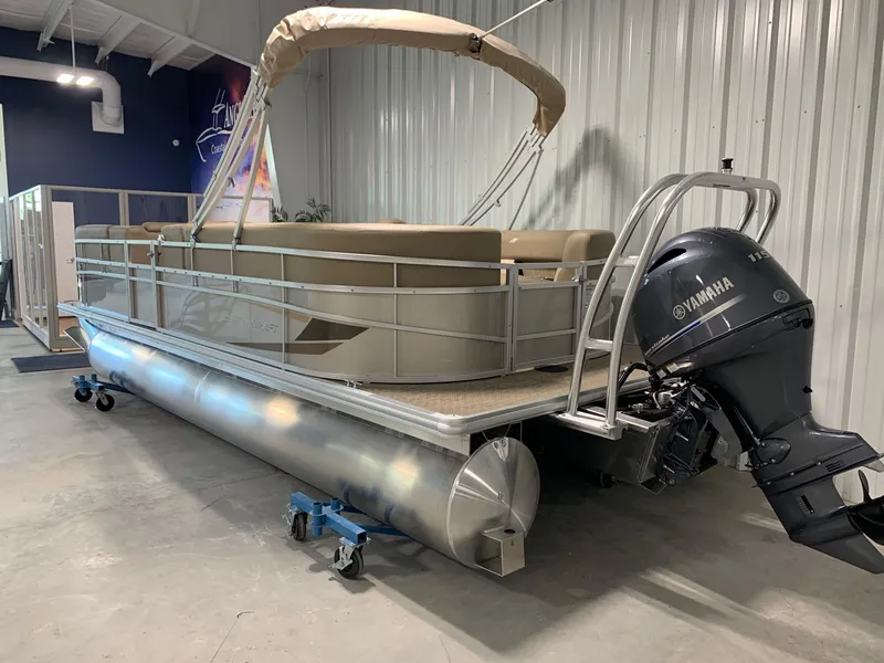 Slide: The Image of 2024 Starcraft LX22 R pontoon boat with Yamaha outboard motor in showroom. - 2