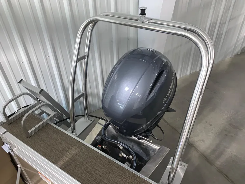 Slide: The Image of 2024 Starcraft LX22 R pontoon boat with outboard motor in storage. - 7