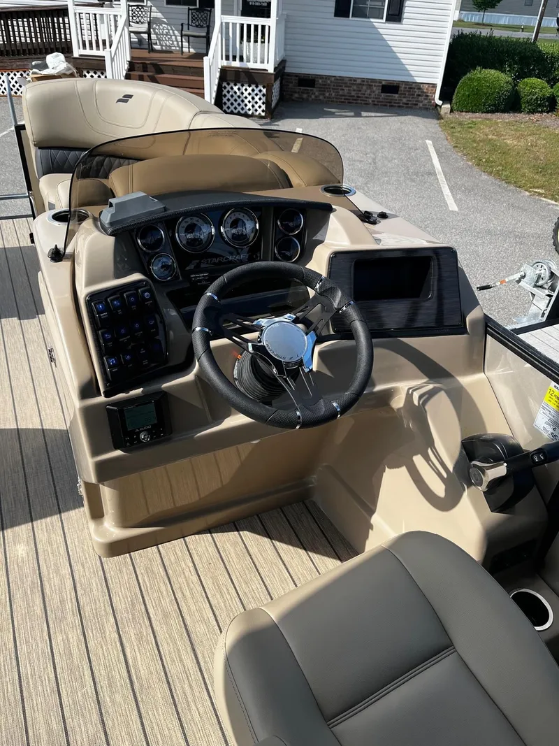 Slide: The Image of 2024 Starcraft SLS 3 boat dashboard with steering wheel and control panel. - 13