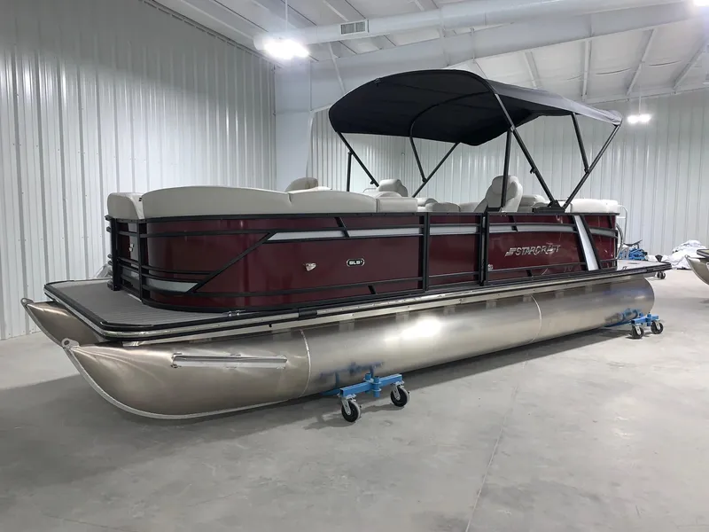 The Image of 2024 Starcraft SLS 3 pontoon boat with maroon exterior in a showroom. - 0