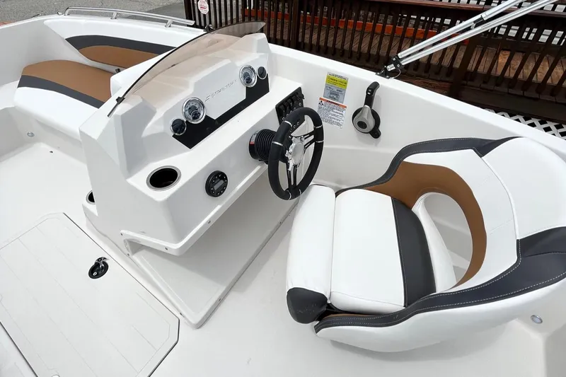 Slide: The Image of 2024 Starcraft SVX 171 boat interior with steering wheel and seating. - 11