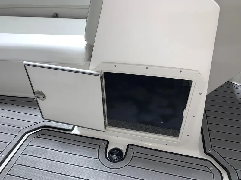 Slide: The Image of 2024 Starcraft SVX 191 boat storage compartment with open door. - 11