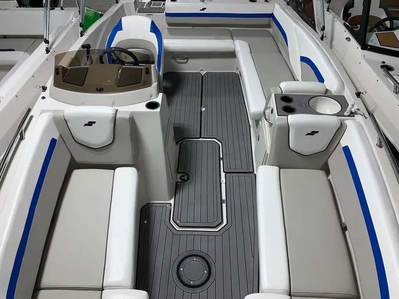 Slide: The Image of 2024 Starcraft SVX 191 boat interior with gray flooring and white seating. - 8