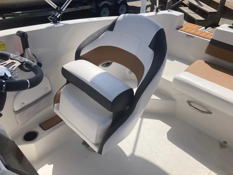 Slide: The Image of 2024 Starcraft SVX 191 boat interior with captain's chair and steering wheel. - 5
