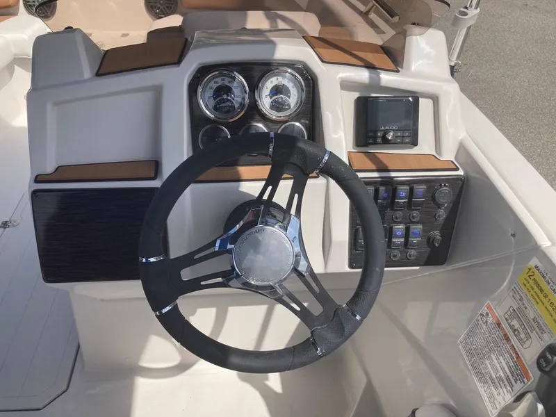 Slide: The Image of 2024 Starcraft SVX 191 boat dashboard with steering wheel and control panel. - 9