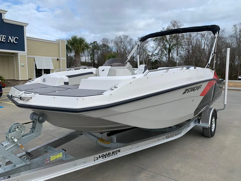 Slide: The Image of 2024 Starcraft SVX 191 boat on Load Rite trailer, parked outdoors. - 2