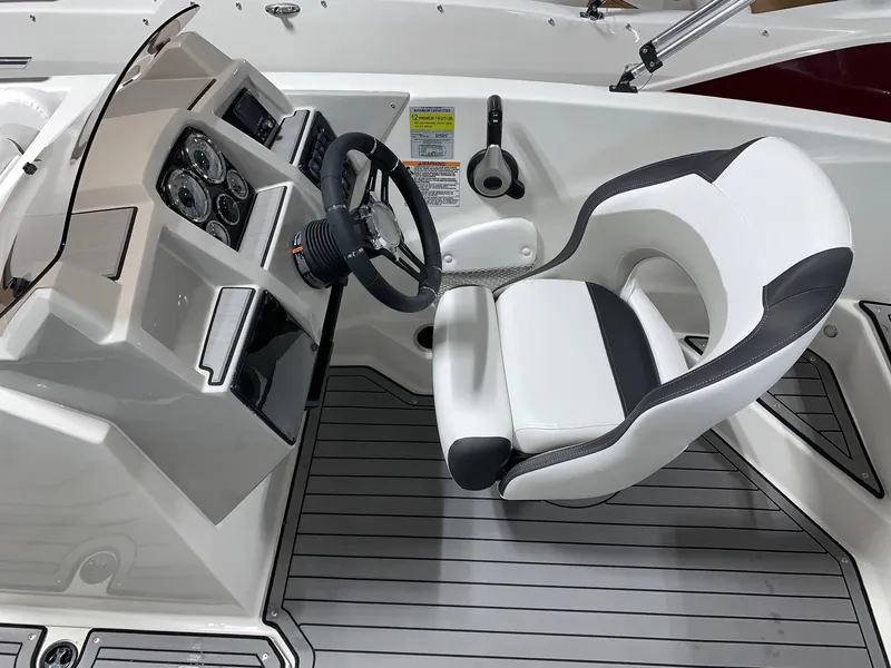 Slide: The Image of 2024 Starcraft SVX 191 boat cockpit with steering wheel and captain's chair. - 5