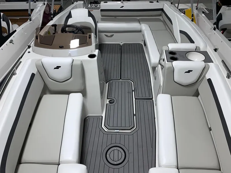 Slide: The Image of 2024 Starcraft SVX 191 boat interior with gray flooring and white cushioned seating. - 9