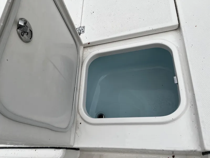 Slide: The Image of Open storage compartment on a 2024 Robalo 266 Cayman boat. - 17
