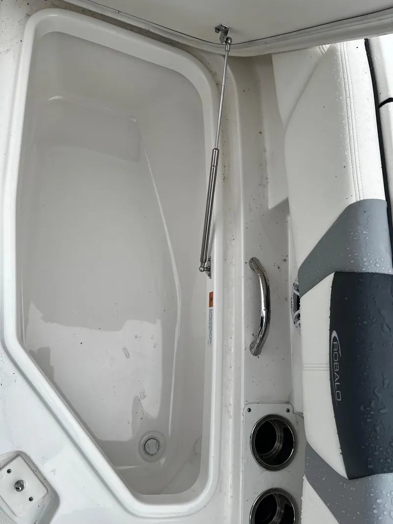 Slide: The Image of 2024 Robalo 266 Cayman boat interior with storage compartment and seating. - 19
