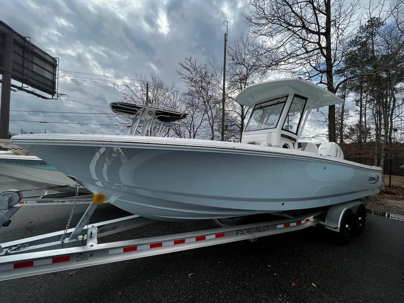 Slide: The Image of 2024 Robalo 266 Cayman boat on trailer, side view, cloudy sky background. - 5