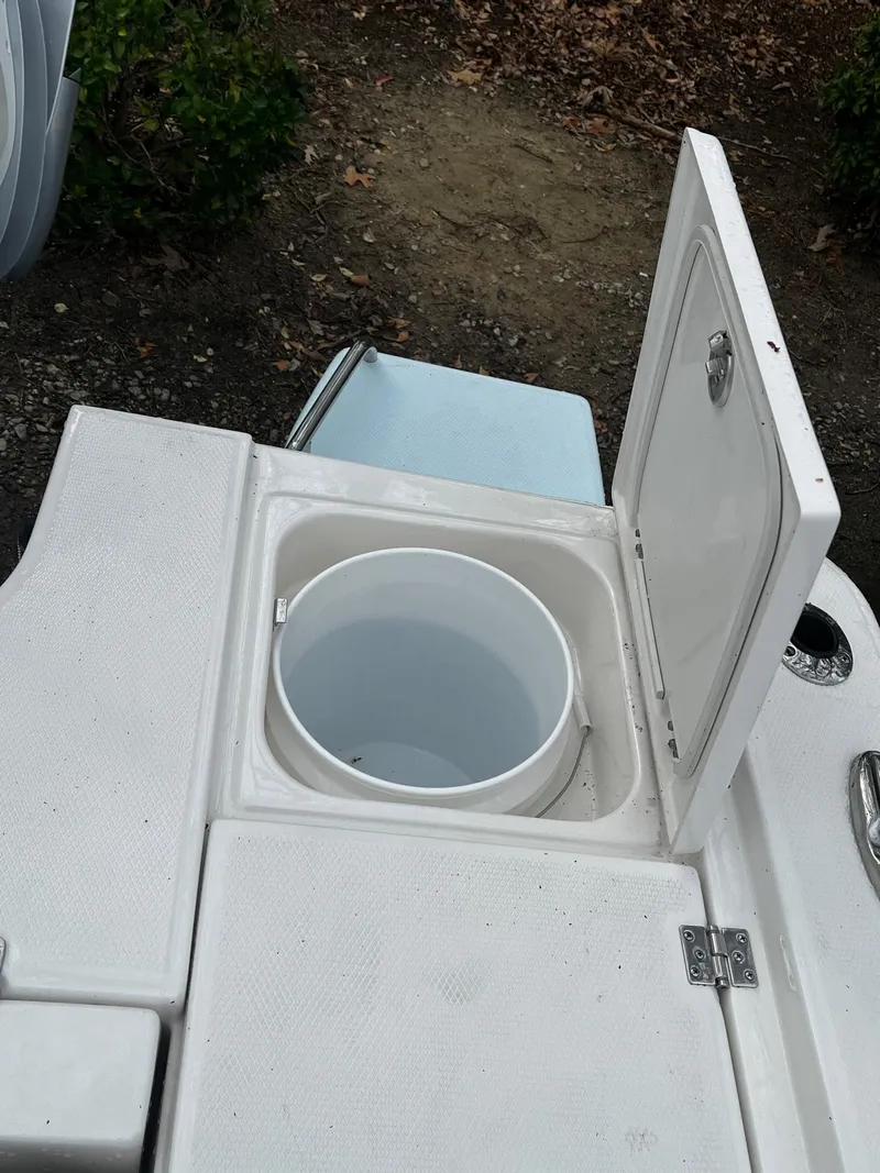 Slide: The Image of 2024 Robalo 266 Cayman boat with open storage compartment. - 9