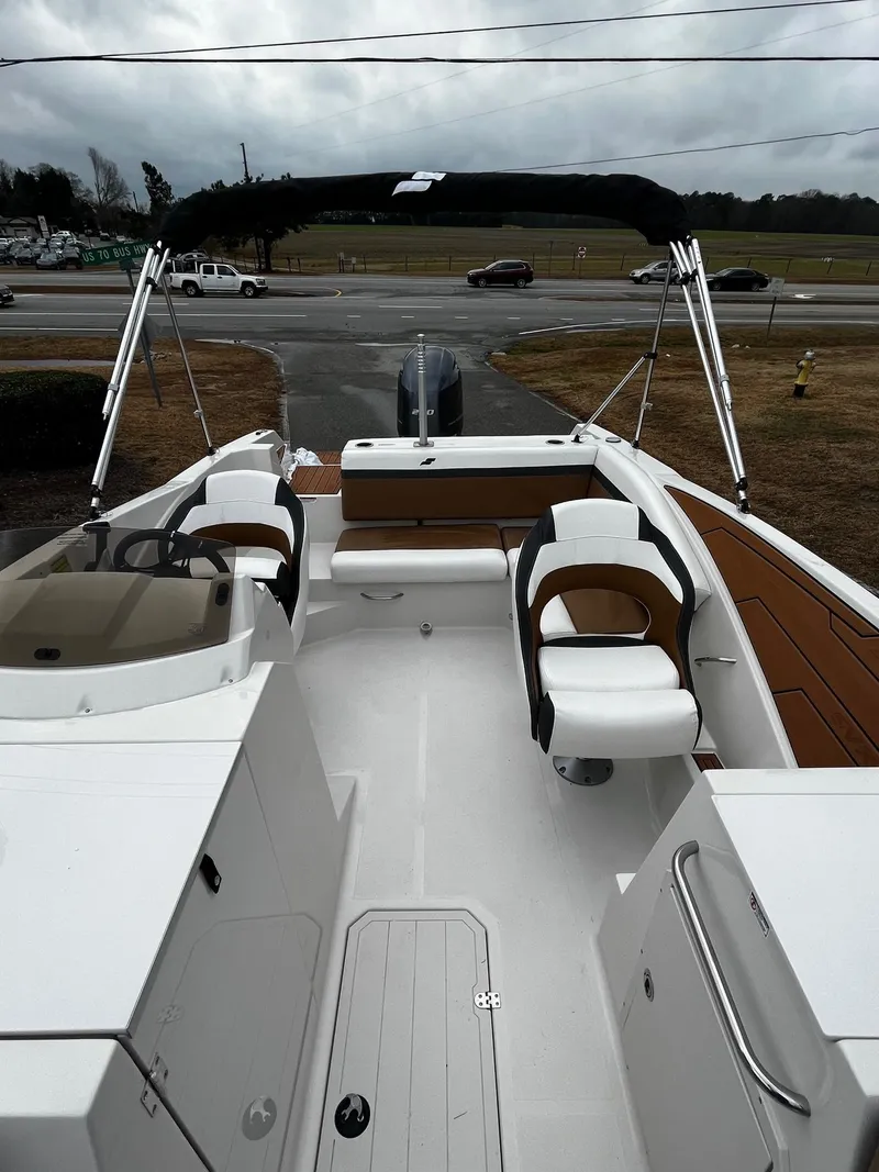 Slide: The Image of 2024 Starcraft SVX 231 boat interior with seating and steering console. - 10
