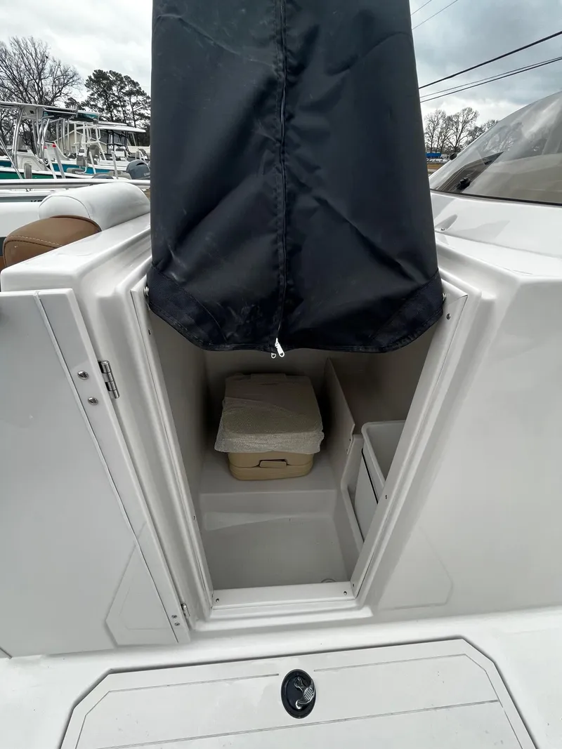 Slide: The Image of 2024 Starcraft SVX 231 boat with open storage compartment. - 13
