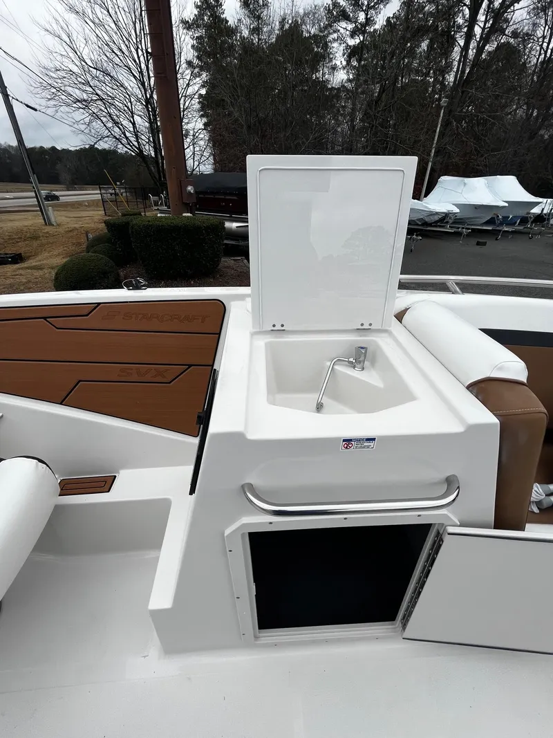Slide: The Image of 2024 Starcraft SVX 231 boat with onboard sink and storage compartments. - 14