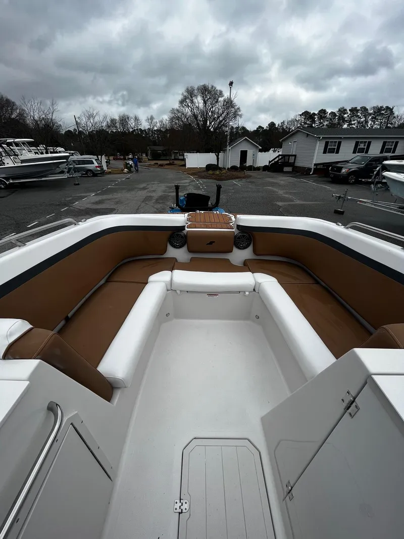 Slide: The Image of 2024 Starcraft SVX 231 boat interior with brown and white seating. - 15
