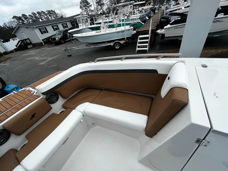 Slide: The Image of 2024 Starcraft SVX 231 boat interior with brown and white seating. - 16