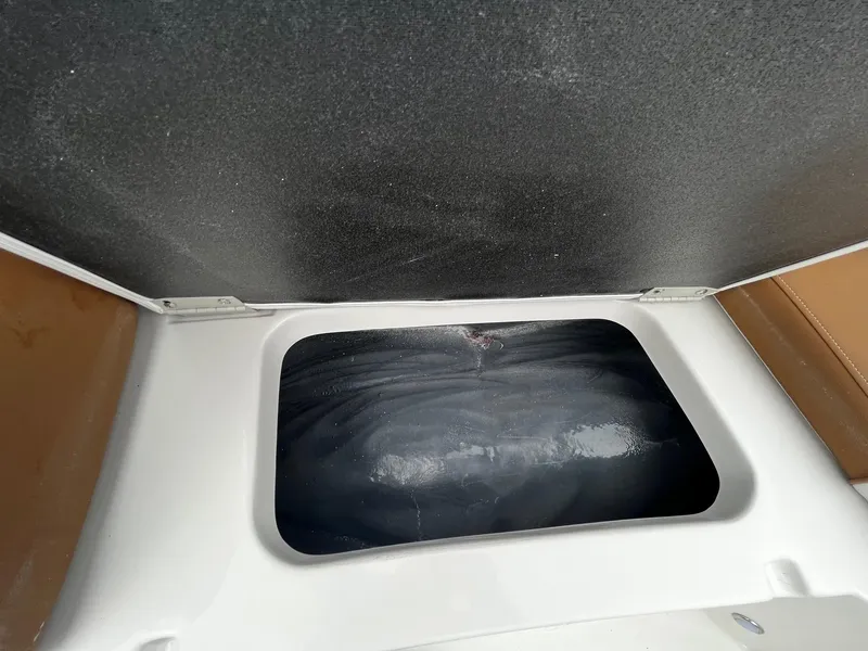 Slide: The Image of 2024 Starcraft SVX 231 storage compartment with open lid. - 18