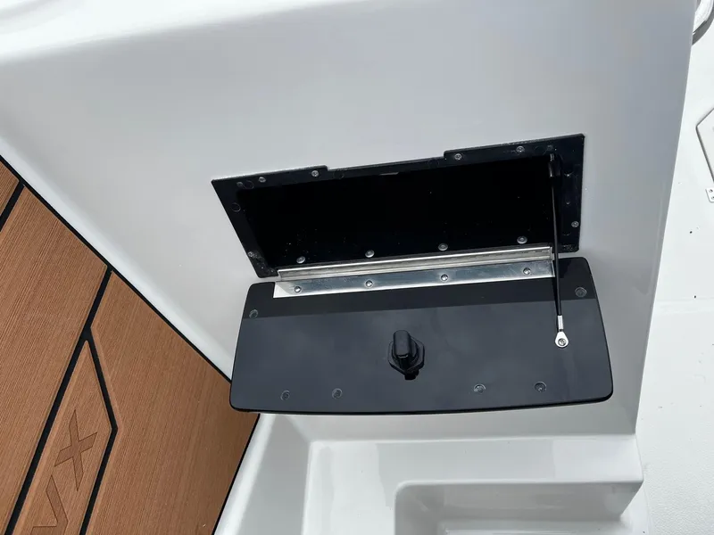 Slide: The Image of 2024 Starcraft SVX 231 boat storage compartment with open black lid. - 22