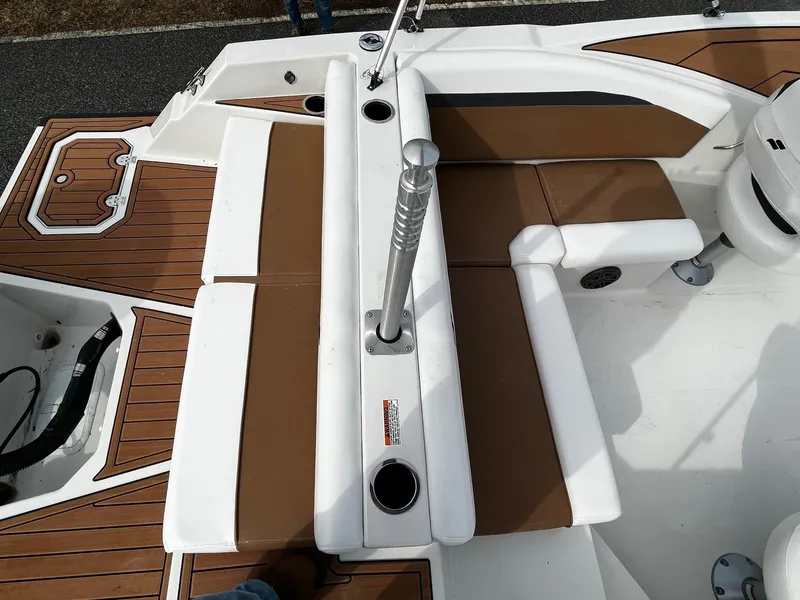 Slide: The Image of 2024 Starcraft SVX 231 boat interior with brown and white seating. - 5