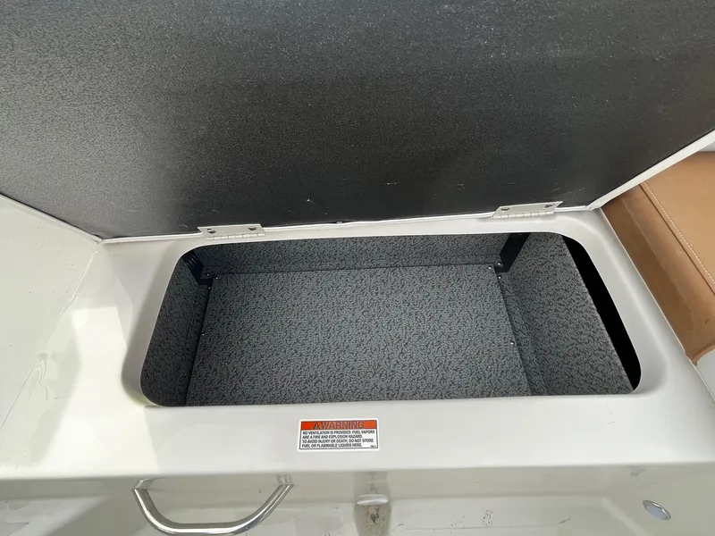 Slide: The Image of 2024 Starcraft SVX 231 boat storage compartment with open lid. - 7