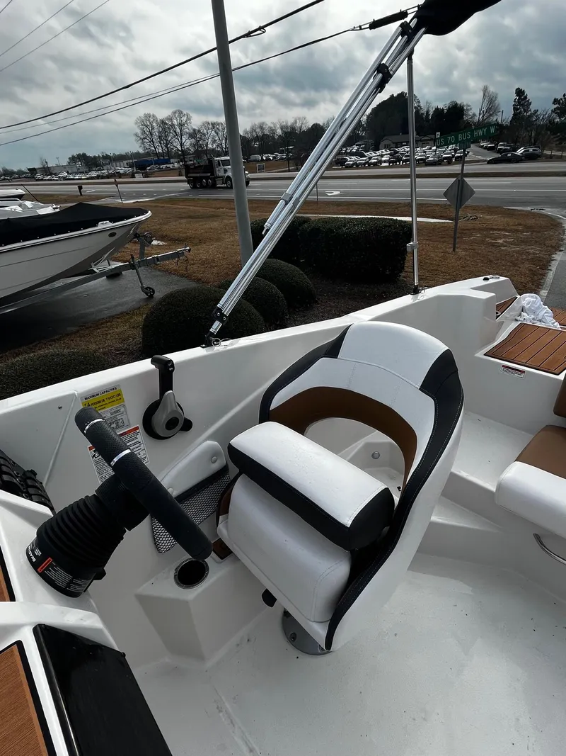 Slide: The Image of 2024 Starcraft SVX 231 boat interior with captain's chair and steering wheel. - 9