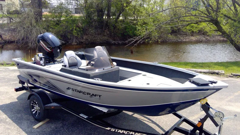 Slide: The Image of 2023 Starcraft Stealth 166 SC fishing boat on trailer by a river. - 1