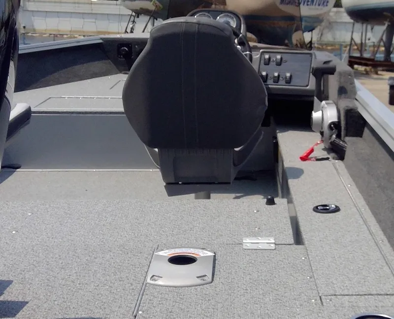 Slide: The Image of 2023 Starcraft Stealth 166 SC boat interior with steering console and seating. - 11