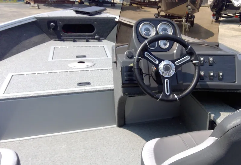 Slide: The Image of 2023 Starcraft Stealth 166 SC boat interior with steering console and seating. - 12