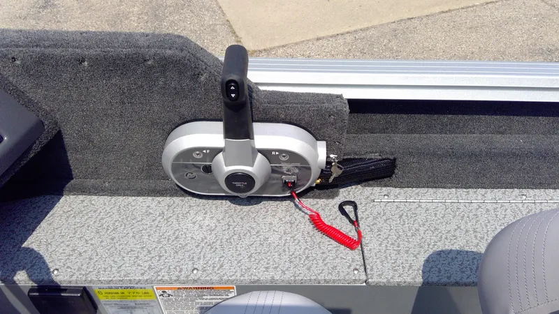 Slide: The Image of 2023 Starcraft Stealth 166 SC boat control panel with throttle lever and safety lanyard. - 14